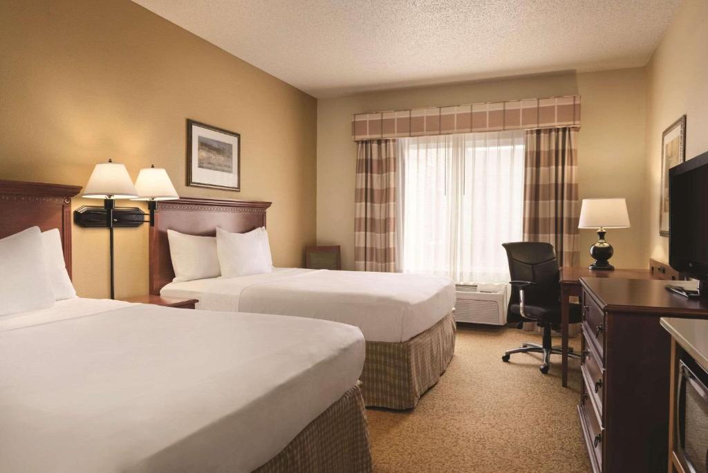 Habitación de hotel con 2 camas y TV en Country Inn & Suites by Radisson, Mankato Hotel and Conference Center, MN, en Mankato