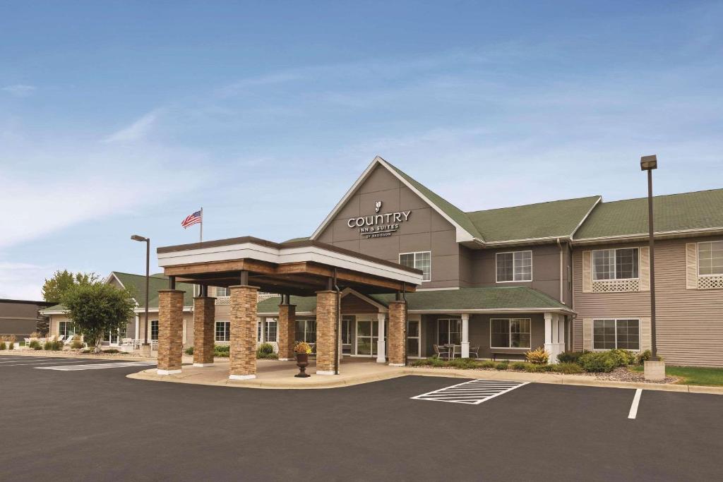 a front view of a hotel with a parking lot at Country Inn & Suites by Radisson, Willmar, MN in Willmar