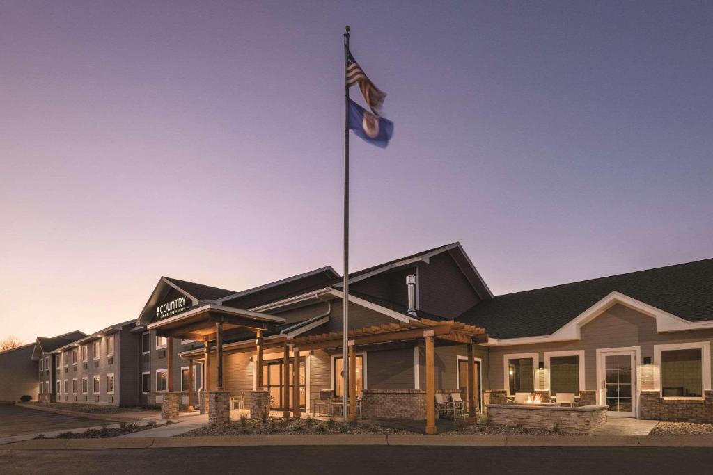諾斯菲爾德的住宿－明尼蘇達州諾思菲爾德雷迪森鄉村套房酒店，建筑物前悬挂的旗帜