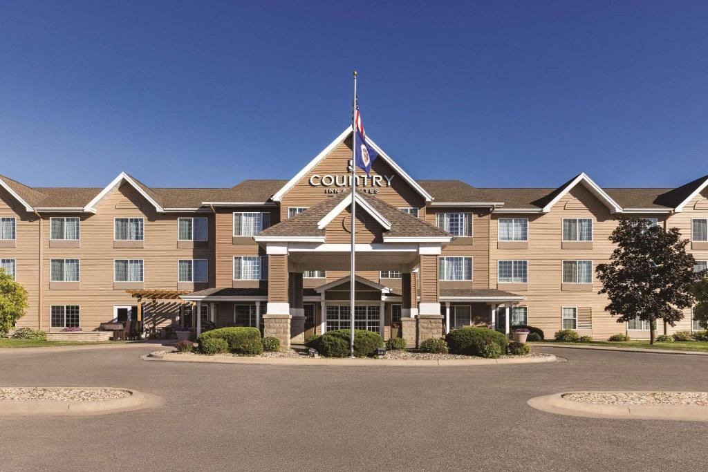 a building with a flag on top of it at Country Inn & Suites by Radisson, Albert Lea, MN in Albert Lea