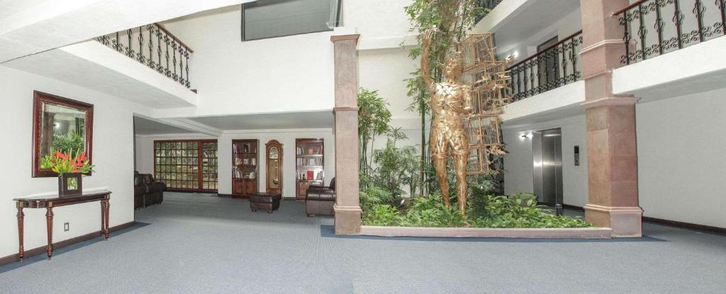 a hallway with a lobby with plants in it at Radisson Hotel & Convention Center Toluca in Toluca