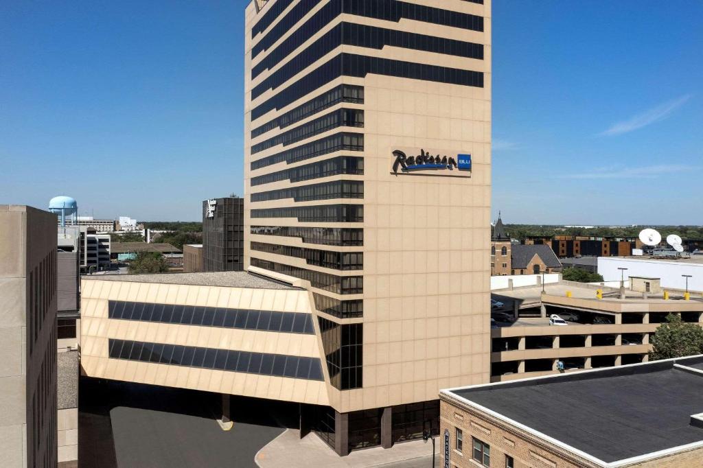 a tall building with a logo on the side of it at Radisson Blu Fargo in Fargo