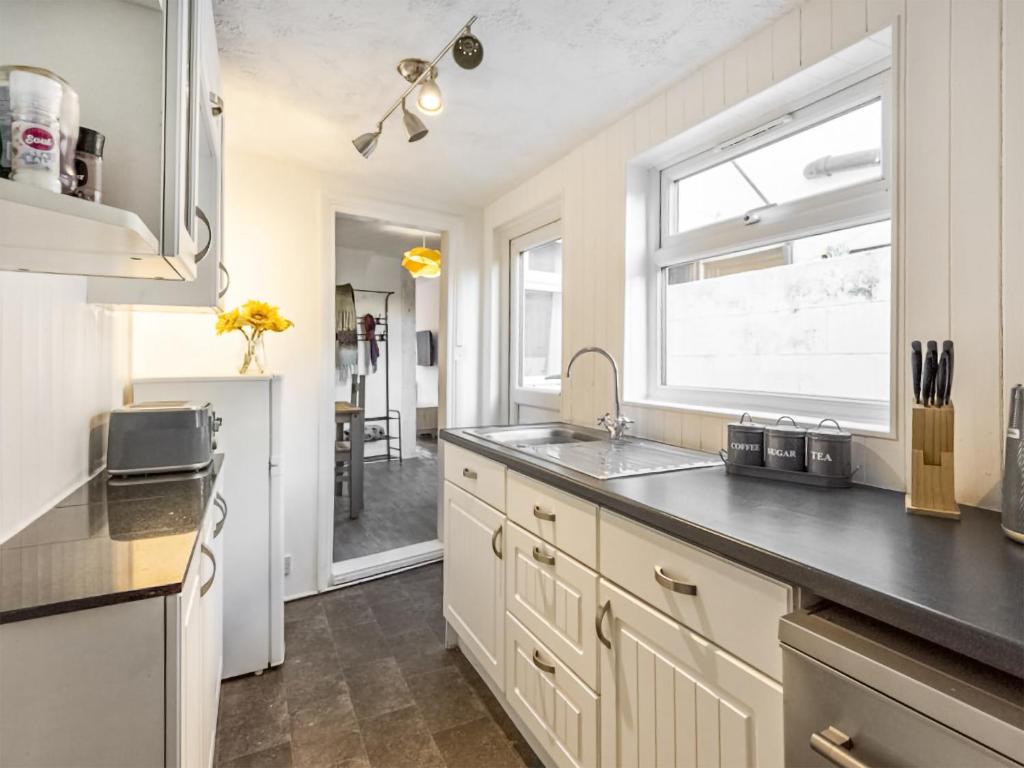 a kitchen with a sink and a window at The Cottage in Gorleston-on-Sea