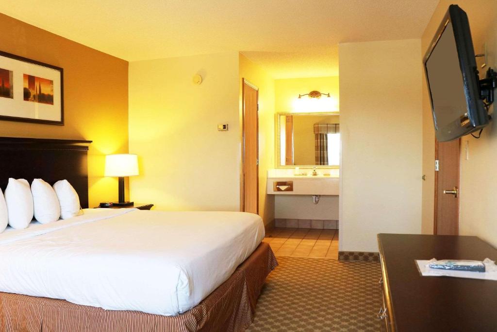 a hotel room with a bed and a television at Country Inn & Suites by Radisson, Lincoln North Hotel and Conference Center, NE in Lincoln