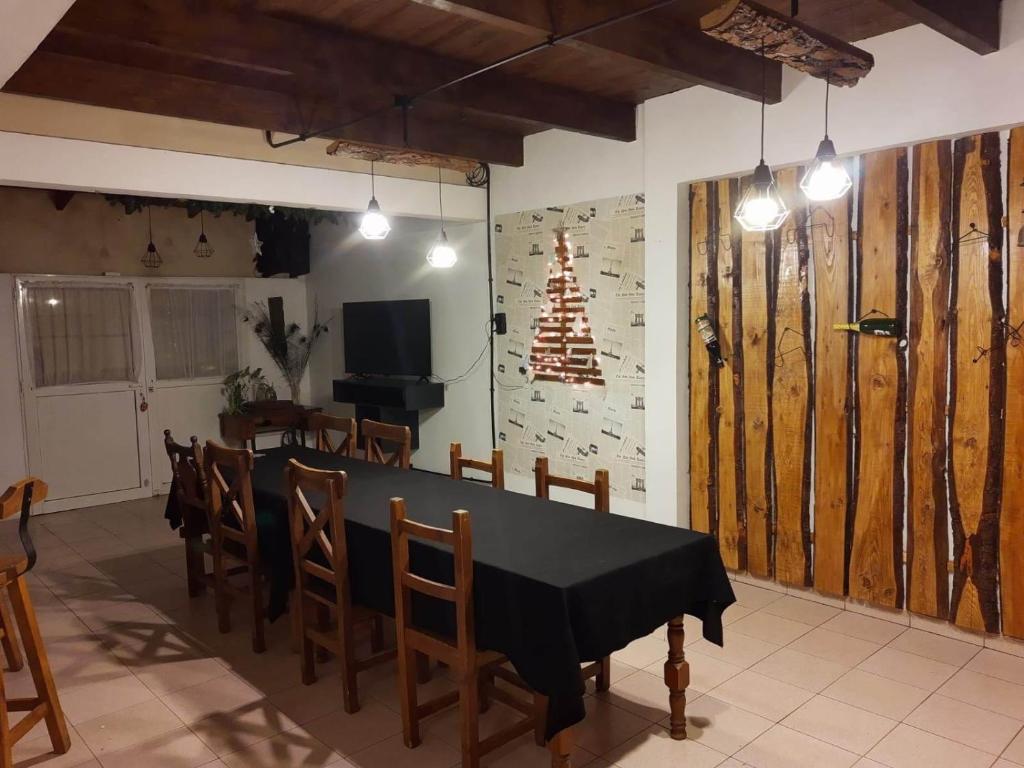 a dining room with a black table and chairs at Mirhouse1 in Puerto Madryn