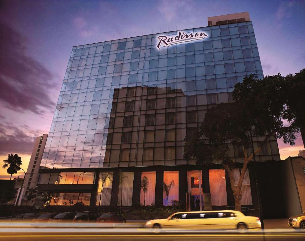 a building with a sign on the side of it at Radisson Hotel Decapolis Miraflores in Lima