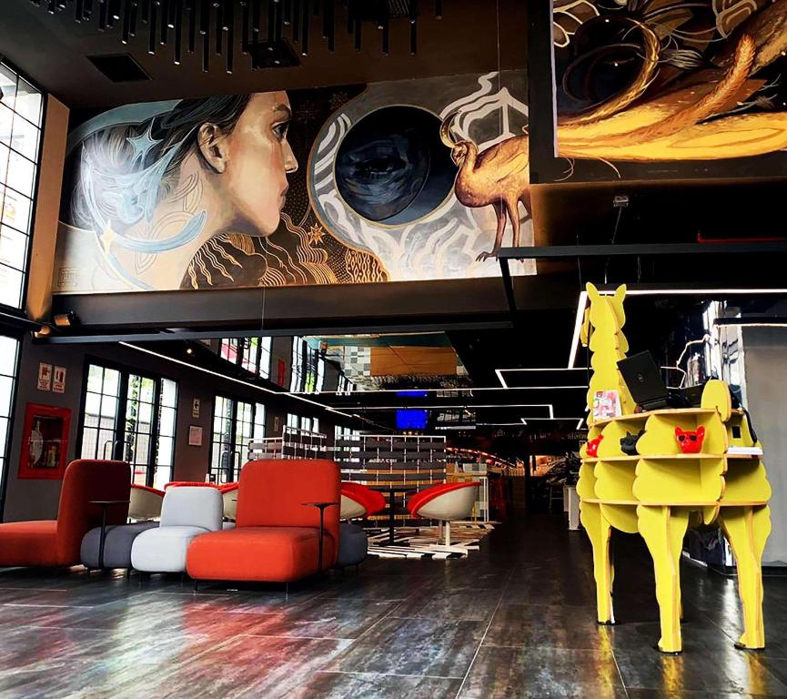 a lobby with a large mural of a woman and a horse at Radisson RED Miraflores in Lima