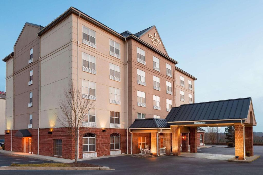 a large building with a parking lot in front of it at Country Inn & Suites by Radisson, Anderson, SC in Anderson