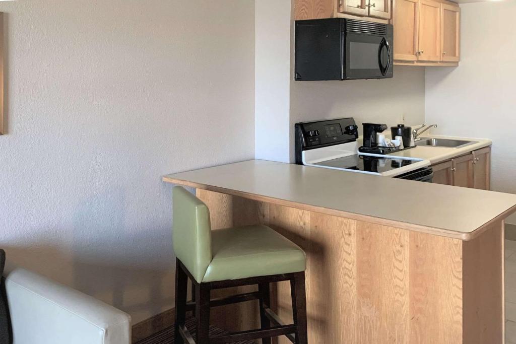 a small kitchen with a counter and a stove top oven at Country Inn & Suites by Radisson, Clarksville, TN in Clarksville