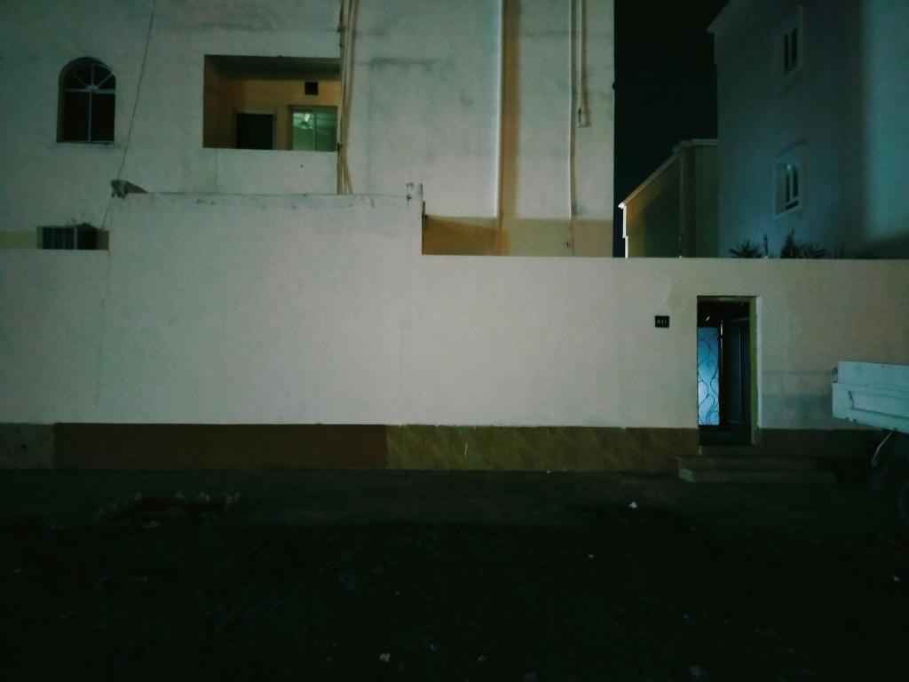 a white wall with a door in a building at Ahjar hostel only ladies in Muscat