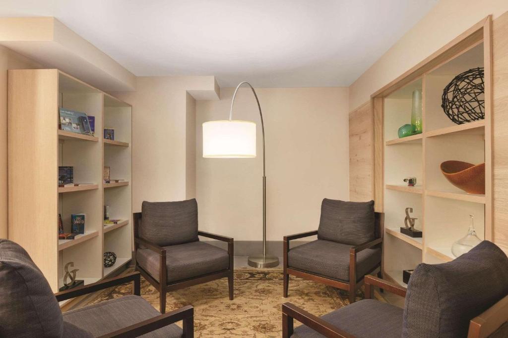 a waiting room with two chairs and a floor lamp at Country Inn & Suites by Radisson, Pigeon Forge South, TN in Pigeon Forge