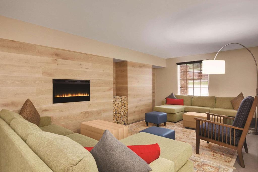 a living room with a couch and a fireplace at Country Inn & Suites by Radisson, Pigeon Forge South, TN in Pigeon Forge
