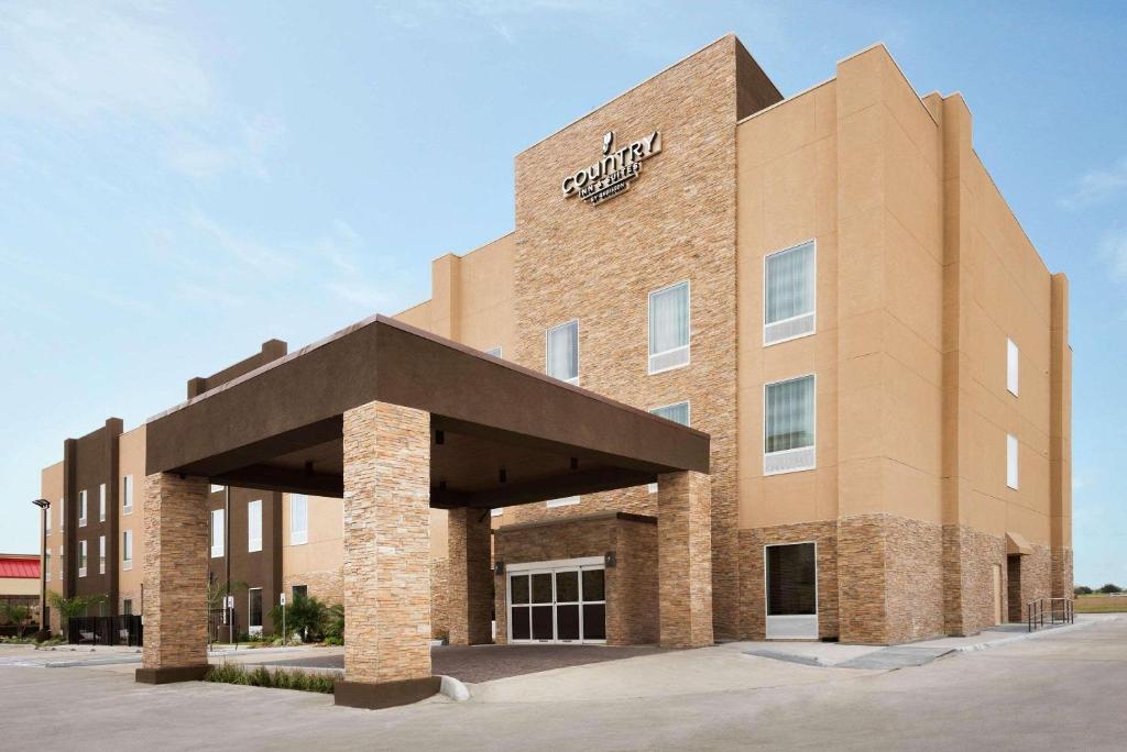 um grande edifício de tijolos com uma placa em Country Inn & Suites by Radisson, Katy (Houston West), TX em Katy