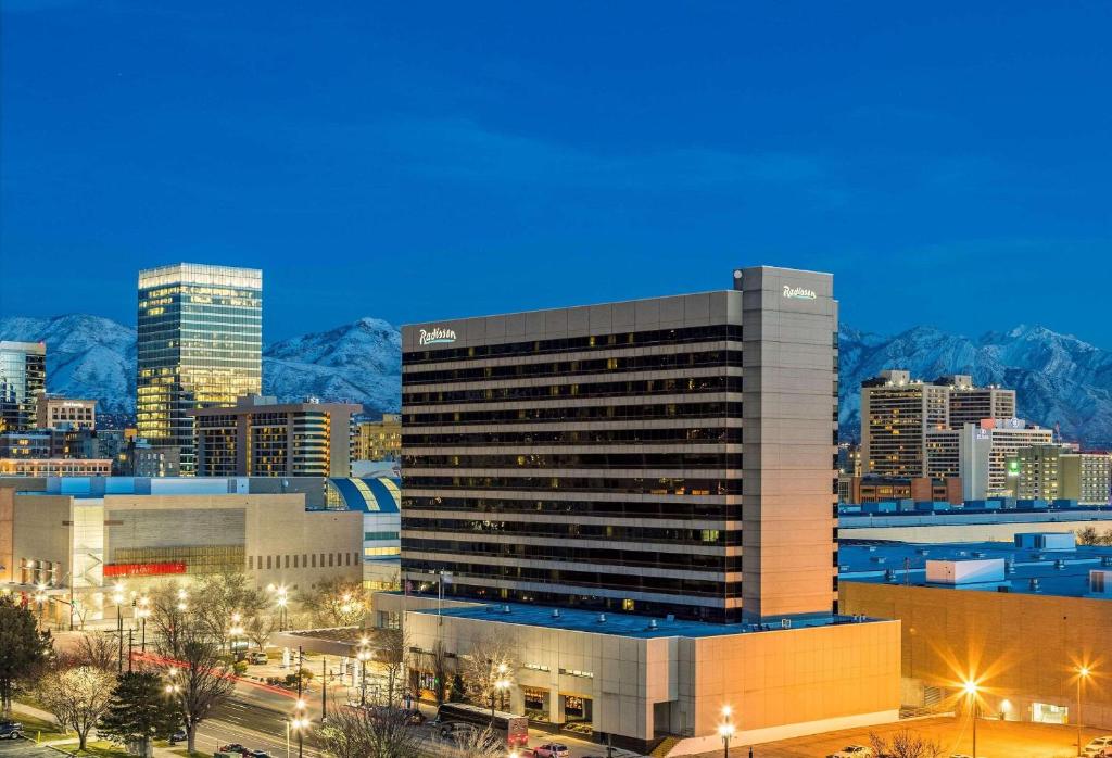 a large building in front of a city at night at Radisson Hotel Salt Lake City Downtown in Salt Lake City