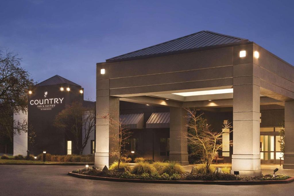 a building with a sign on the front of it at Country Inn & Suites by Radisson, Seattle-Bothell, WA in Bothell