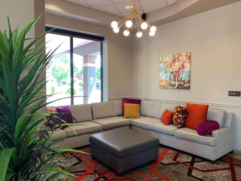 a living room with a couch with colorful pillows at Radisson Hotel River Falls in River Falls