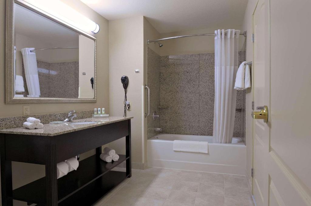 a bathroom with a sink and a tub and a shower at Country Inn & Suites by Radisson, Beckley, WV in Beckley