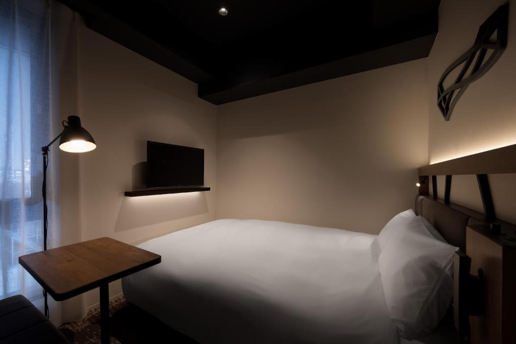 Postel nebo postele na pokoji v ubytování Nest Hotel Osaka Umeda