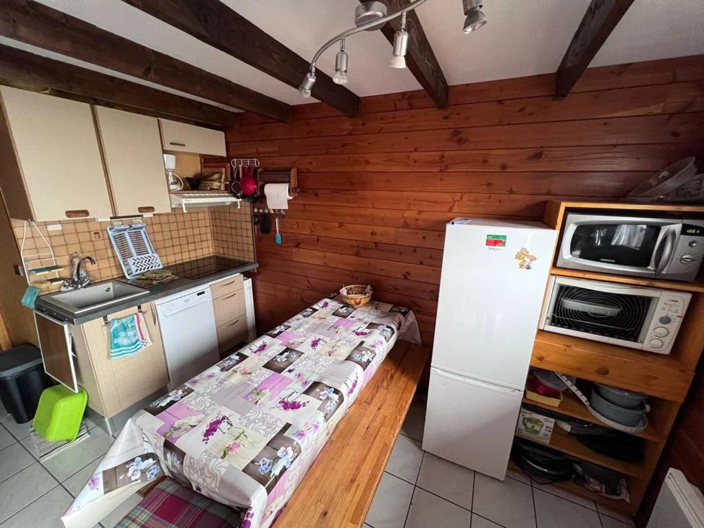 a small kitchen with a bed and a refrigerator at Chalet Les Angles, 4 pièces, 6 personnes - FR-1-593-107 in Les Angles