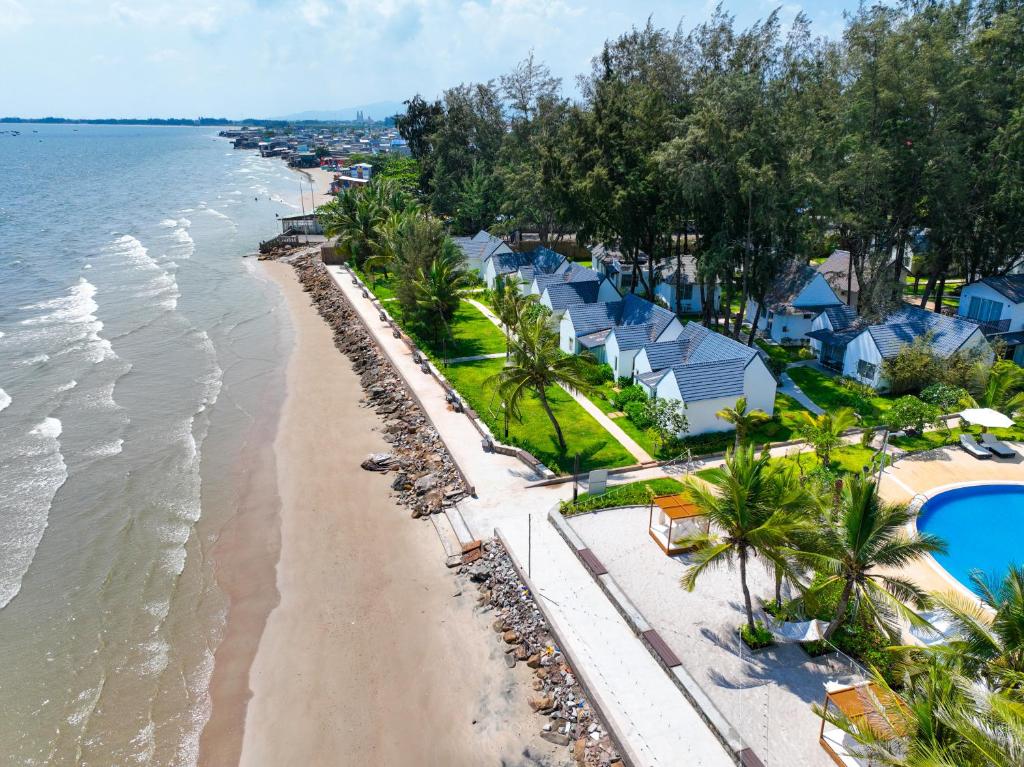 eine Luftansicht auf einen Strand mit Häusern in der Unterkunft Palace Long Hai Resort & Spa in Long Hải