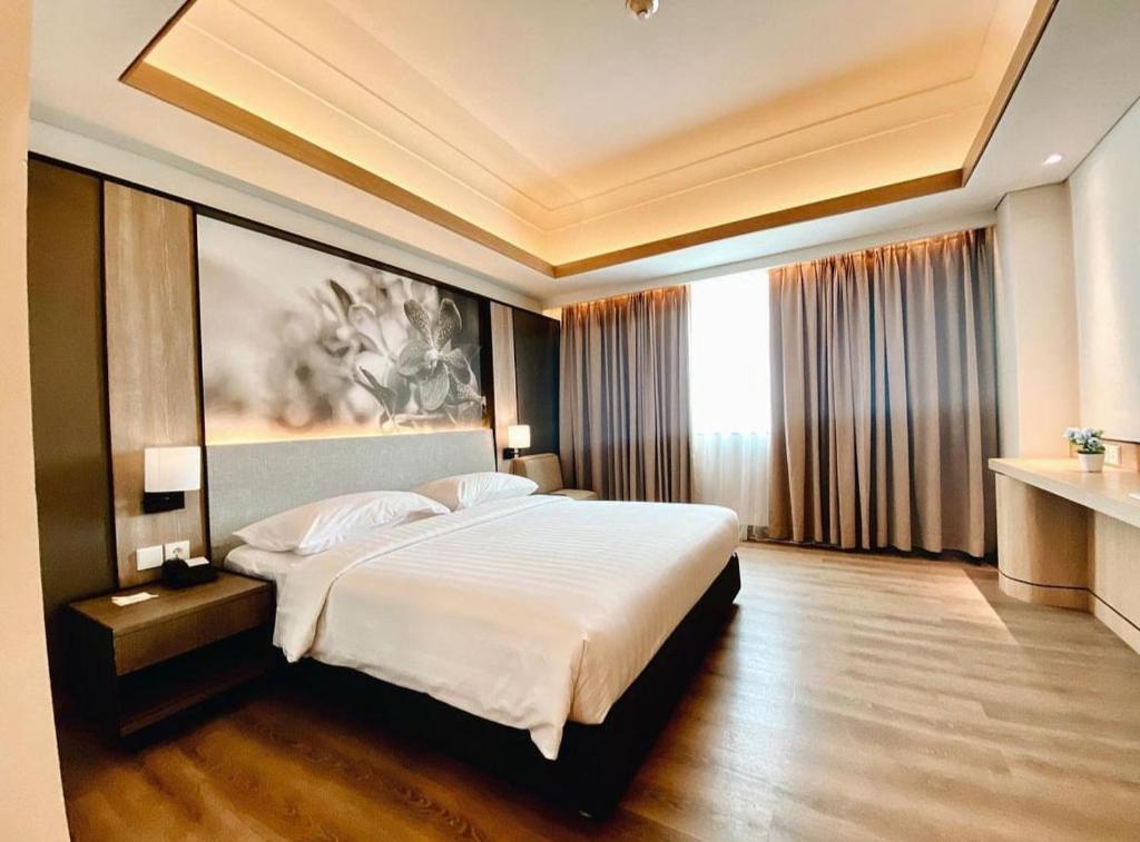 sypialnia z dużym łóżkiem w pokoju hotelowym w obiekcie Orchardz Jayakarta w Dżakarcie