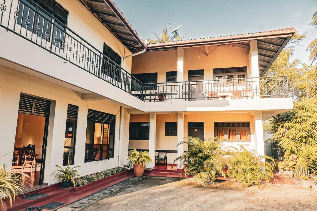 an image of a house with a balcony at Sunny Lanka Guest House in Matara