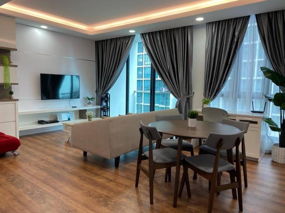 a living room with a table and a couch at Vivacity Megamall Jazz Suite Kuching 8pax 3BR #Joyoustayz in Kuching