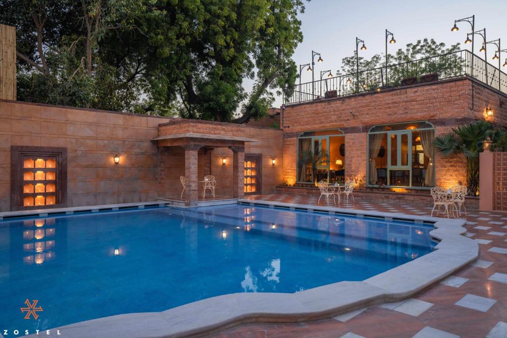 a swimming pool in front of a house at Zostel Jodhpur (Ratanada) in Jodhpur