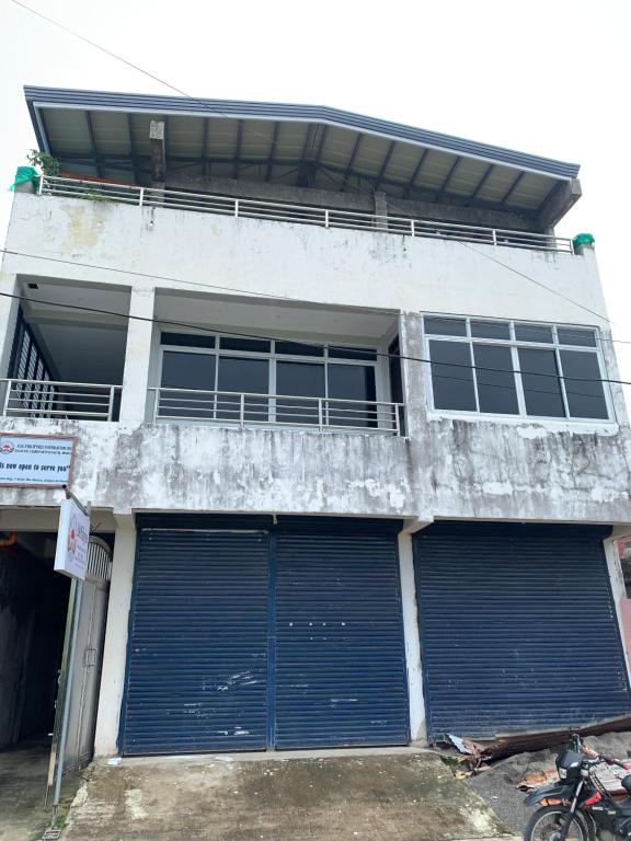 a building with two garage doors and a balcony at Tending's Rendezvous in Santa Monica