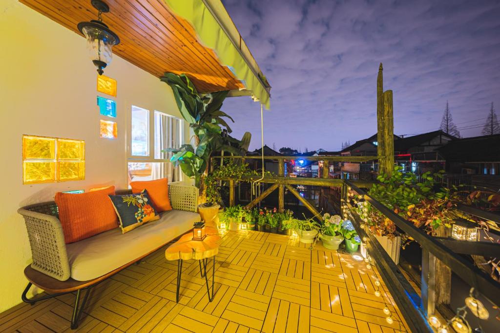 a balcony with a couch and some plants at Shanghai River View Villa in Shanghai