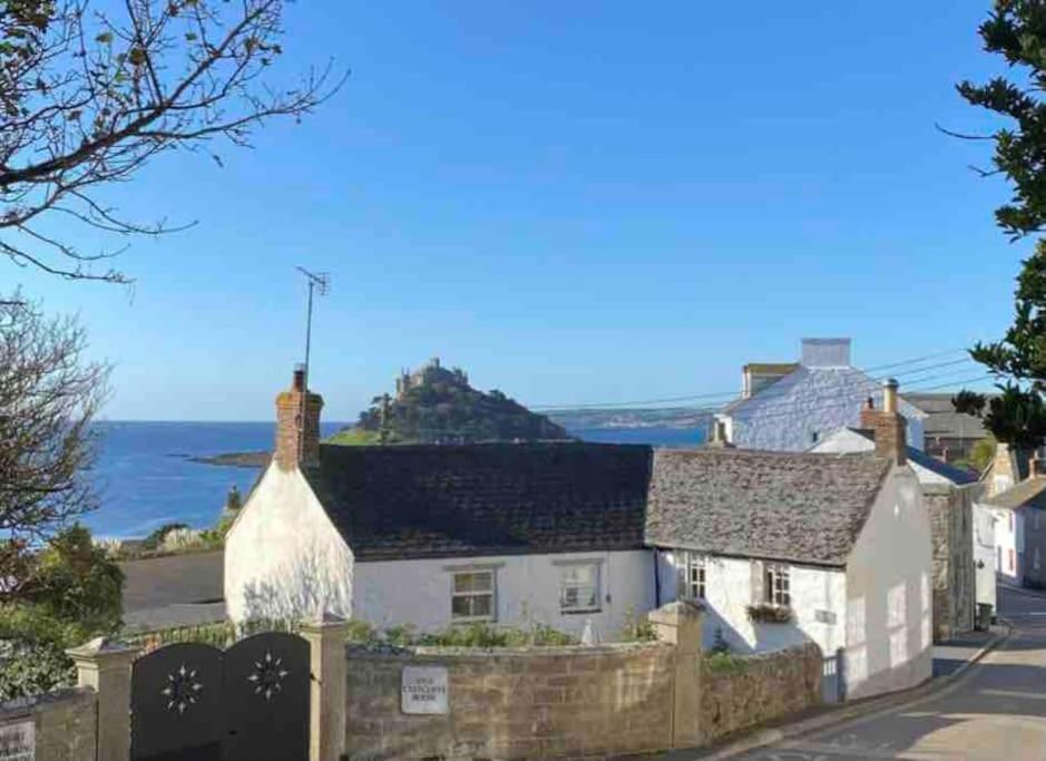 a cottage with a view of the ocean at Cosy Cottage Central Marazion with Parking in Marazion