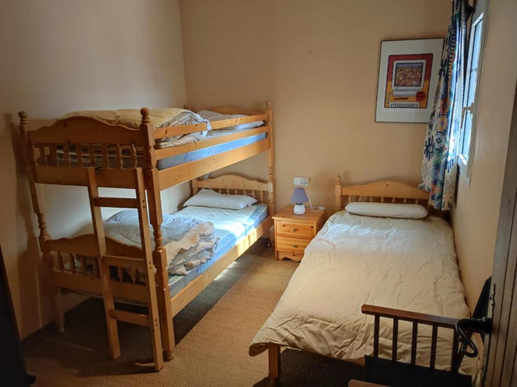 two bunk beds in a room with two beds at Urb. Bugaboos - Sierra Nevada in Monachil