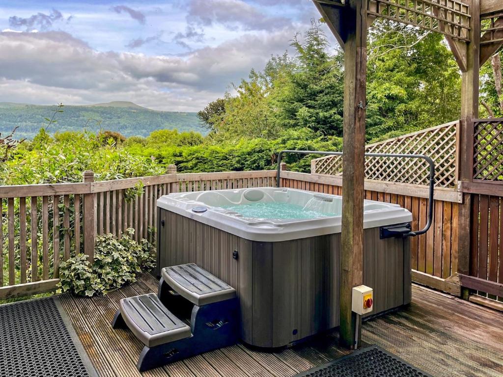 a hot tub on the deck of a house at 1 Bed in Gilwern 52882 in Gilwern