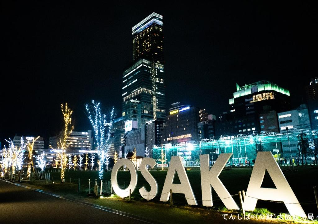 a large sign in front of a city at night at APA Hotel Tennoji Ekimae in Osaka
