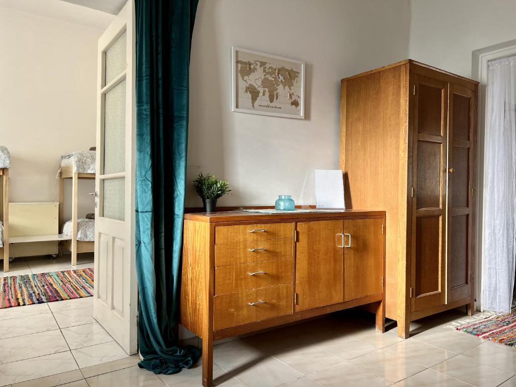 a room with a wooden cabinet and a dresser at Retro Hostel in Limassol