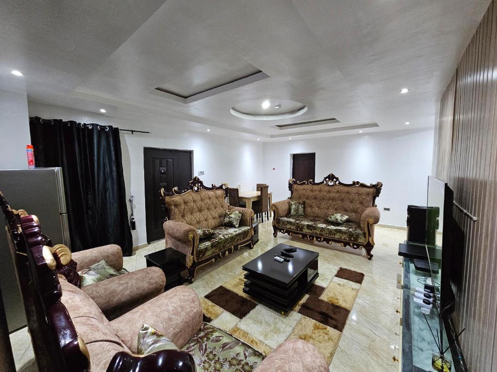 a living room with couches and a table at Serene Oasis in Ikorodu