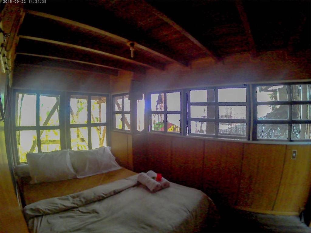 Postel nebo postele na pokoji v ubytování Karang Aji Beach Villa