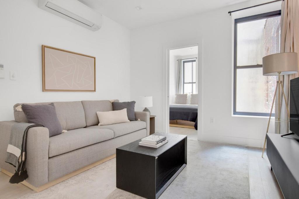 a living room with a couch and a table at Cobble Hill 1BR w in-unit WD nr Trader Joes NYC-728 in Brooklyn