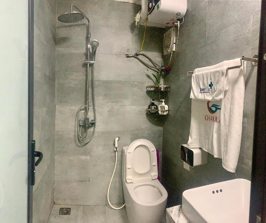 a bathroom with a shower and a toilet and a sink at Natural Light STU 402 Near Uncle Ho's Mausoleum in Hanoi