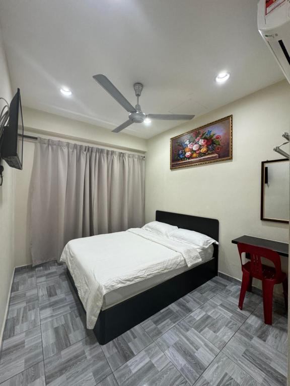En eller flere senger på et rom på 西子楼 CZI Budget Hotel Sungai Siput