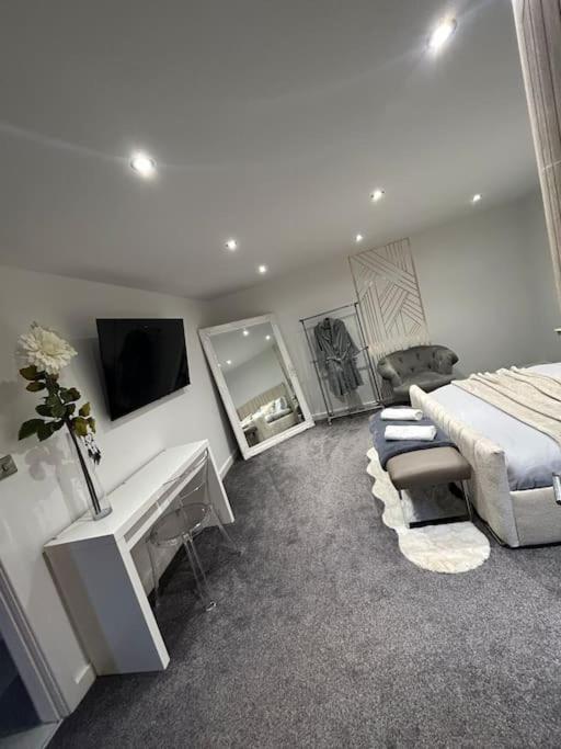 a bedroom with a bed and a desk and a tv at Secret Cabin Getaway in Hartlepool