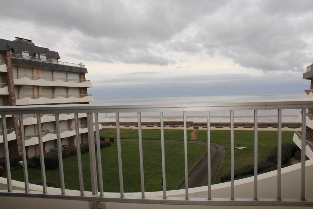 a balcony with a view of the ocean at 450 - A ERQUY, en bordure de la très belle plage de CAROUAL in Erquy