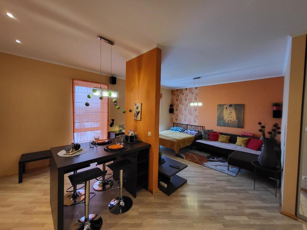 a living room with a table and a couch at Solaris Studio Apartments in Rīga