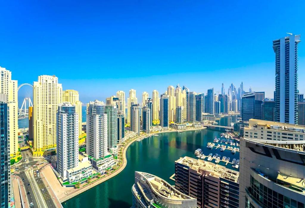 a view of a city with a harbor and buildings at Luxury 1 Bedroom With Sea View in Dubai