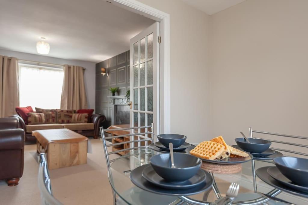 a living room with a glass table with bowls on it at Leed City Centre - Armley Wortley in Leeds