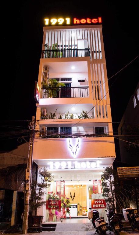 a tall building with a sign on top of it at 1991 Hotel Phan Thiết in Phan Thiet