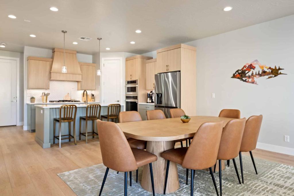 a kitchen and dining room with a wooden table and chairs at Paddle and Play townhouse in St. George