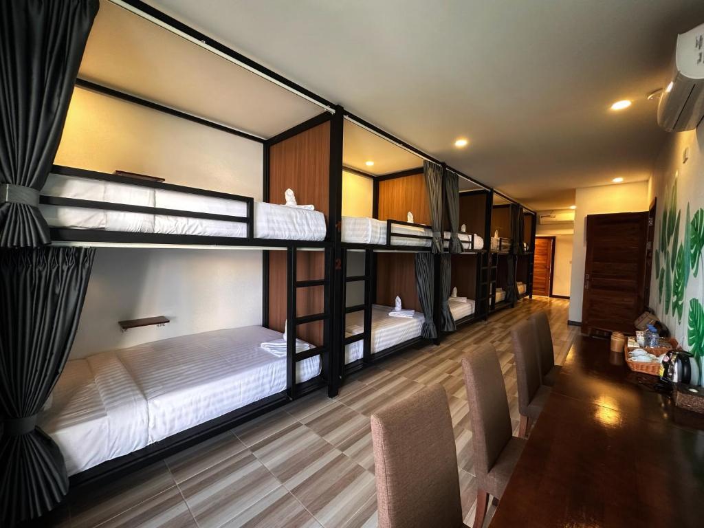 a room with three bunk beds in it at Hostel by Monsoon Riverside in Phnom Penh