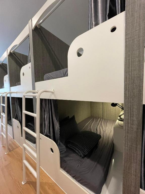 a couple of bunk beds in a room at Alphabet Home Capsule in Ho Chi Minh City