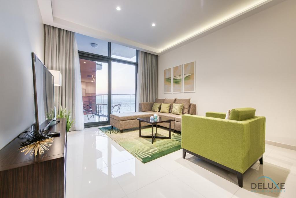 a living room with a couch and a table at Cordial 1BR at Celestia B Dubai South by Deluxe Holiday Homes in Dubai